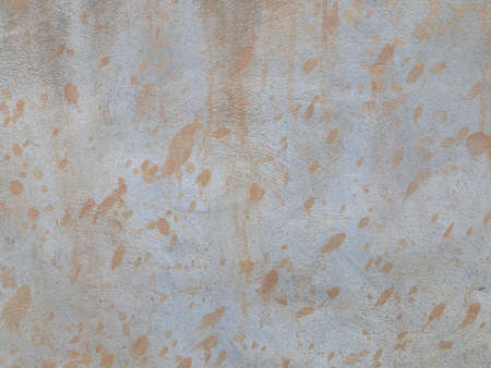 light brown dots stains are all over the white cement wall in the full frame shotの写真素材