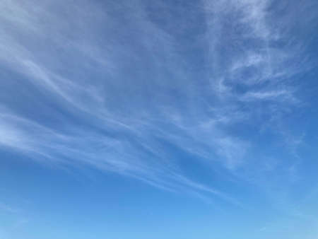 light pale white clouds on the blue sky in natural daylight, using for the backgroundの写真素材