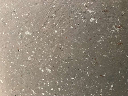 splash white paint color on a rough gray cement wall in a full frame shotの写真素材