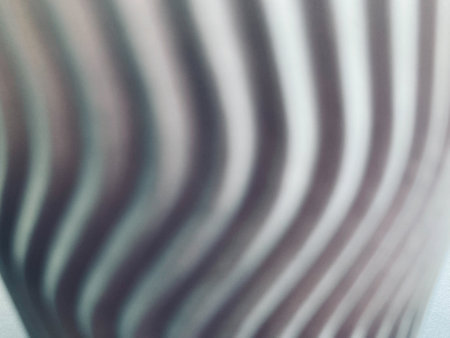 blurred swirl grey paper with white light at the bottom in full frame shot, using for the background