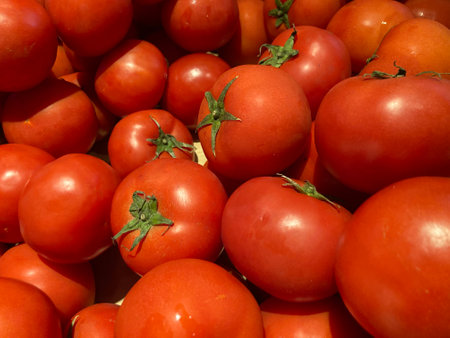 Full frame shot of many fresh red tomatoes in the indoor vegetable market, using as backgroundの写真素材