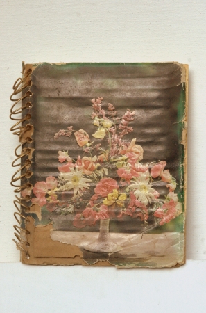 Very old diary with vintage flower picture at the cover of book.の素材