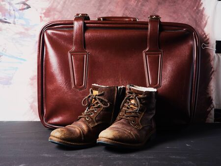 pictured are brown stylish boots and accessories. It can be a suitcase, bag or gloves. Background in color shoes.の写真素材