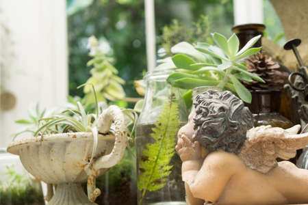 Decorative small cupid ceramic figure in the bottleの写真素材