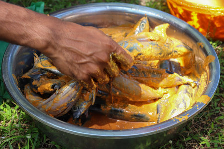Fish in a bucket of water at the temple in thailand.の写真素材
