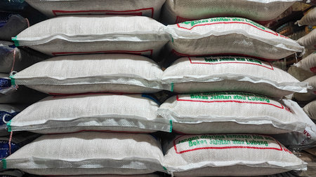 Bags of white wheat flour for sale at a market stall.の写真素材