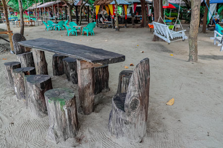 Wooden table and chairs on the beach at Pattaya, Thailand