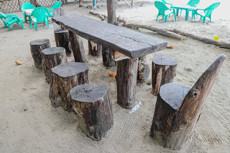 Wooden table and chairs on the beachの写真素材