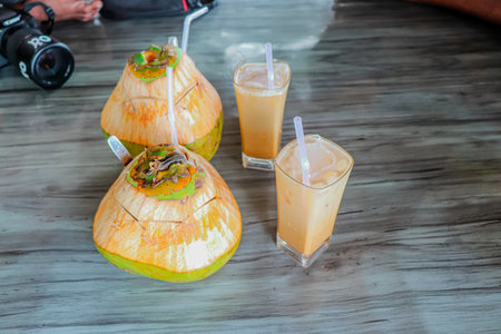 Coconut milk and smoothie on wood table, Thailand.の写真素材