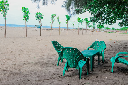 green chairs on the beach in Thailand,vintage color tone.の写真素材