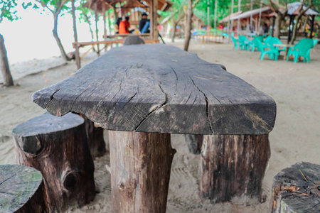 Wooden table and chairs on the beach at Koh Samui, Thailandの写真素材