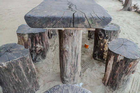 Wooden table and chairs on the beach in Koh Lanta, Thailandの写真素材