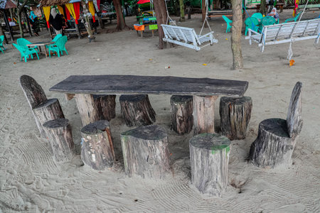 Wooden table and chairs on the beach in Phuket, Thailandの写真素材