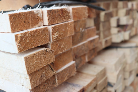 Stack of new wooden studs at construction site, closeup of photoの写真素材