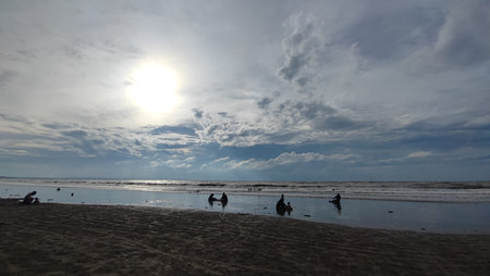 Sunset on the beach with people on the sand