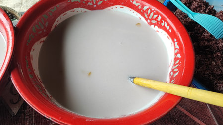 Closeup of a bowl of liquid with a brush on topの写真素材