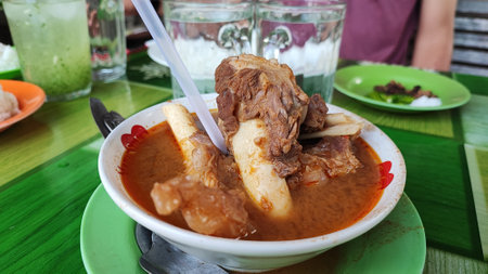 Pork stewed with rice in a bowl on the table.の写真素材