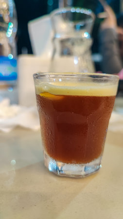 Coffee in a glass on a table in a cafe.の写真素材