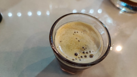 Coffee in a glass on a table in a cafe.の写真素材