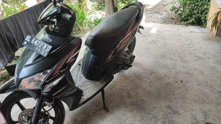 Black scooter parked on the street.の写真素材