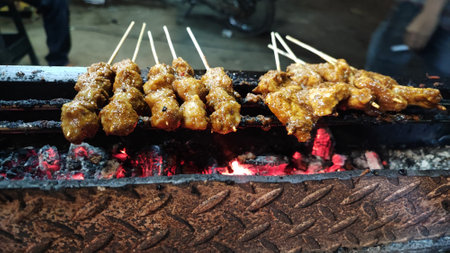Fried chicken on the grill in a street food market.の写真素材
