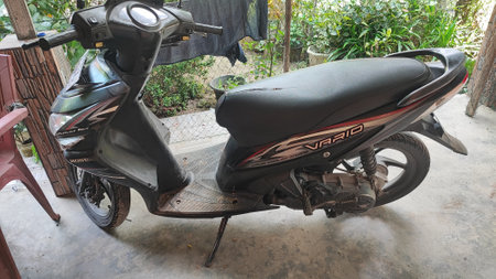 Vintage scooter parked in the street.の写真素材