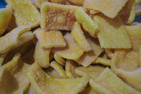 close up of a pile of dumpling chips in a market stallの写真素材