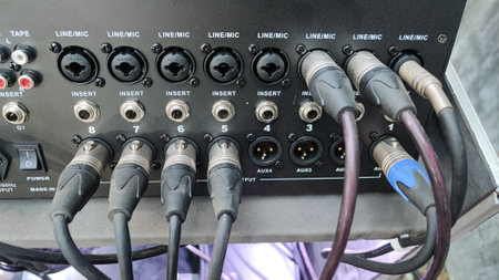 Close-up of audio and video cables connected to an amplifier.