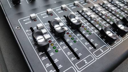 Close up of a professional audio mixing console in a recording studio.