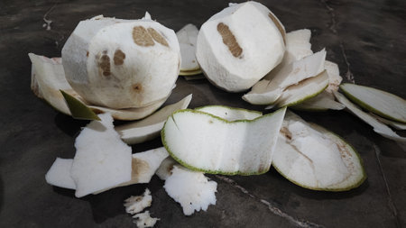 Coconut cut in half on a black background, Thailand.