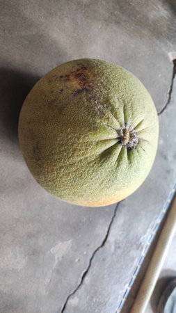 Green pomelo fruit on the old wooden table.
