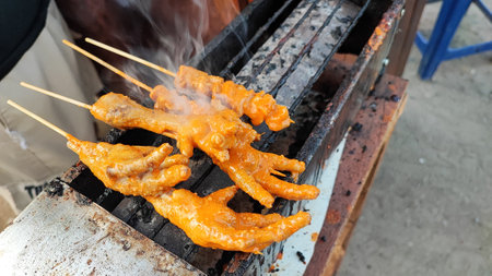 grilled chicken on the coals in thailand street food marketの写真素材