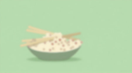Blurred background of rice bowl with chopsticks and space for textの素材