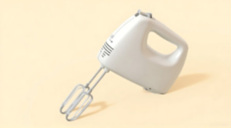 Closeup of a hand mixer on a yellow background with copy spaceの素材