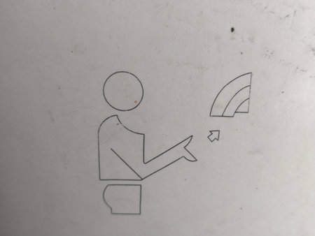 A minimalistic line drawing on a textured light grey surface shows a person pointing towards a wireless connection symbol, indicating interaction.の写真素材