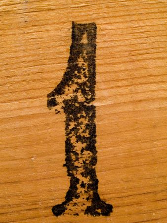 Black number one on wooden surfaceの写真素材
