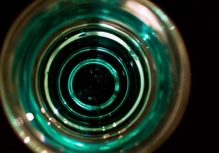 Inside a shot glass - abstract view of a shot glass of absinth.の写真素材