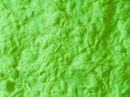 An abstract background of green paper pulp close-up.の写真素材