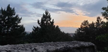 old stone fence, stones against a cloudy sky, dark cloudy skyの写真素材