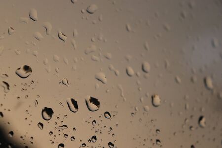 raindrops on glass, evening rainの写真素材