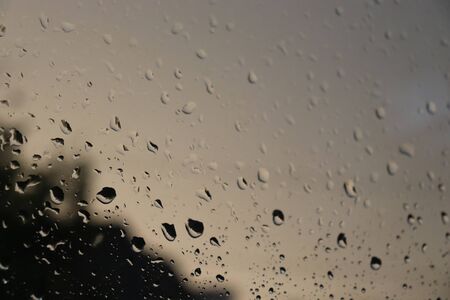 raindrops on glass, evening rainの写真素材