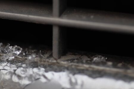 winter, ice and snow on a metal grill auto, macroの写真素材