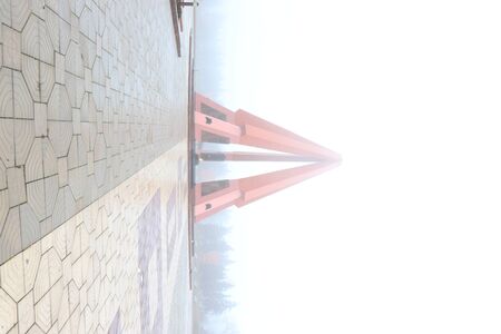 red columns in the form of a pyramid in the fog stretch to the skyの写真素材