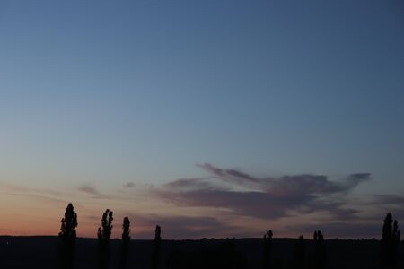 the sun through the gray clouds in the eveningの写真素材