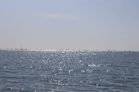 sea water, blue sky, sunny horizon and boatsの写真素材