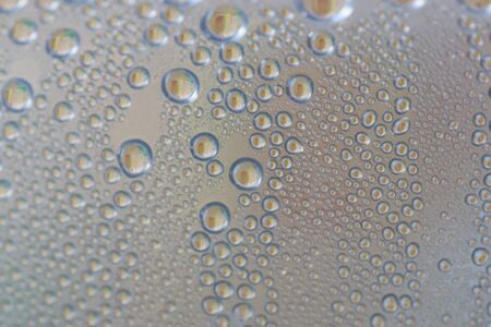 water drops on a transparent plastic surface, macro view of waterの写真素材