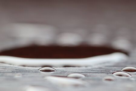 drops of water on a burgundy surface with a resemblance like a treeの写真素材
