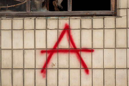 big letter "a" in red paint on an old wallの写真素材