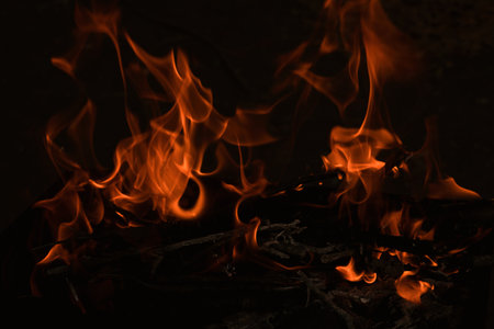 flames in the dark, a bright fire on a dark backgroundの写真素材