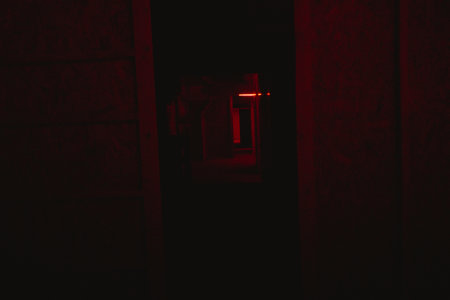 Silhouette of a door in a dark room with red lightの写真素材